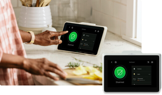 Homelife woman in kitchen using Homelife touchscreen control panel